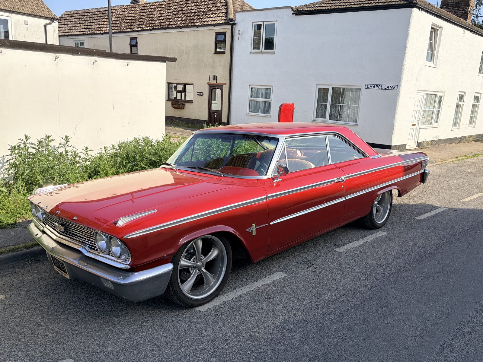 Red 1963&frac12; Ford Galaxie fastback, registration BOF 81A, parked on Chapel Lane, seen from the front three-quarter