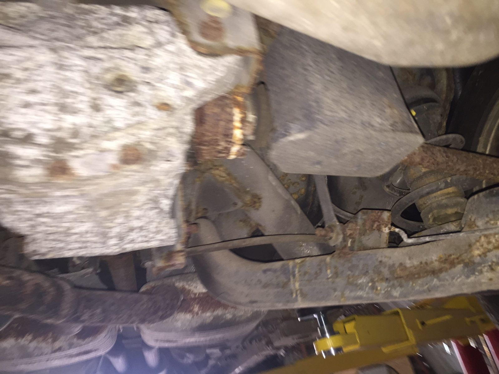 Rear suspension with a rusty coil spring and brake disc