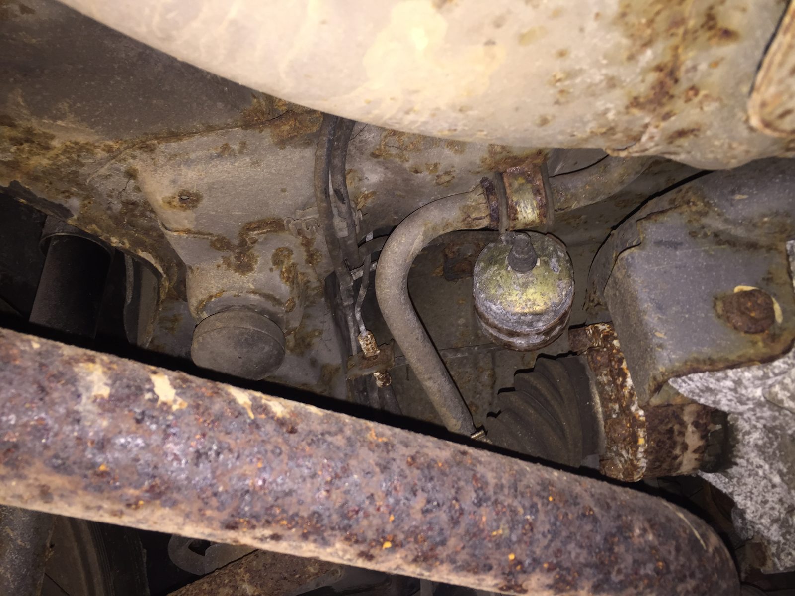 Close view of the rusty rear suspension and exhaust