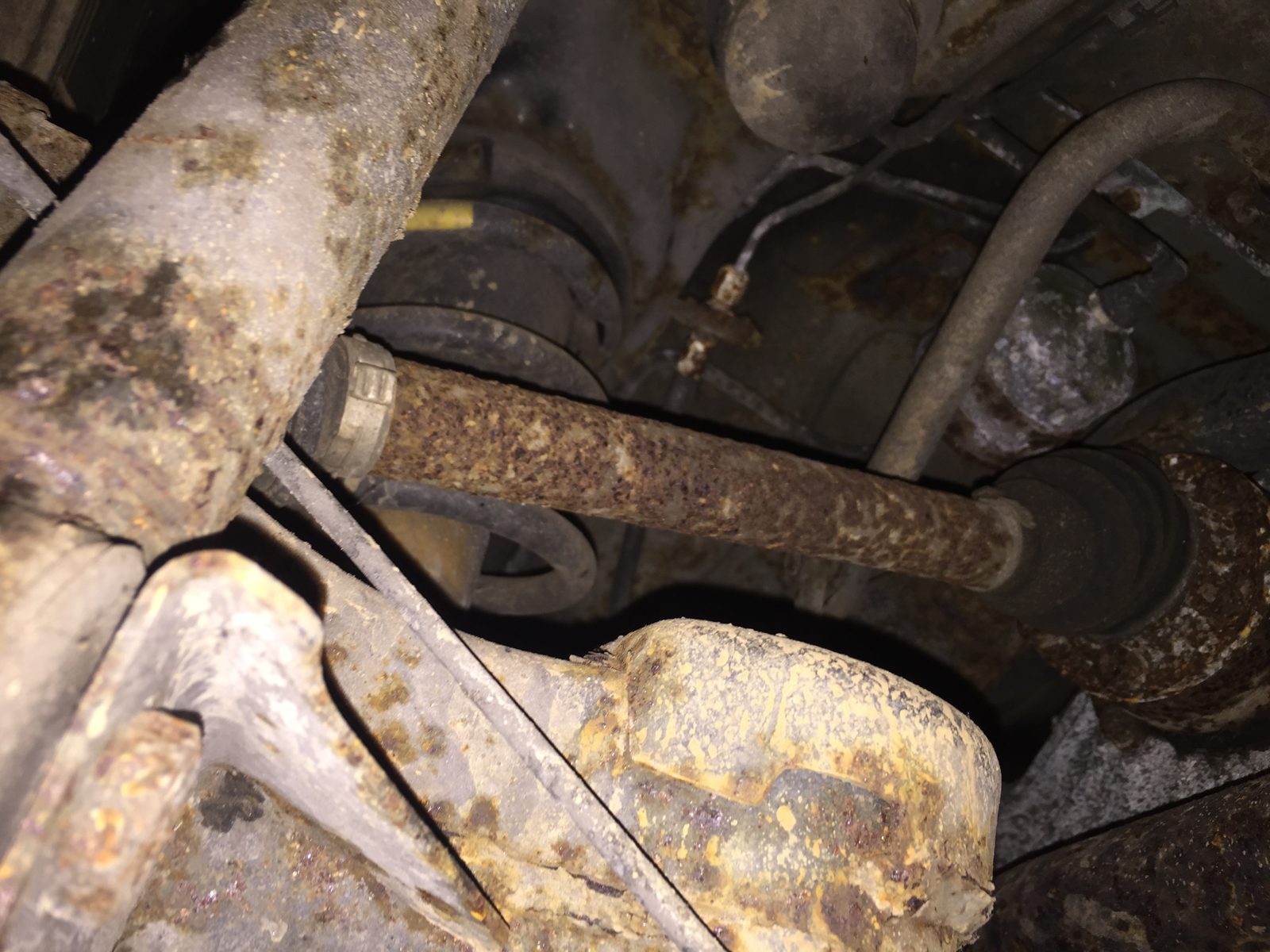Another view under the rear, with rusty suspension and the exhaust