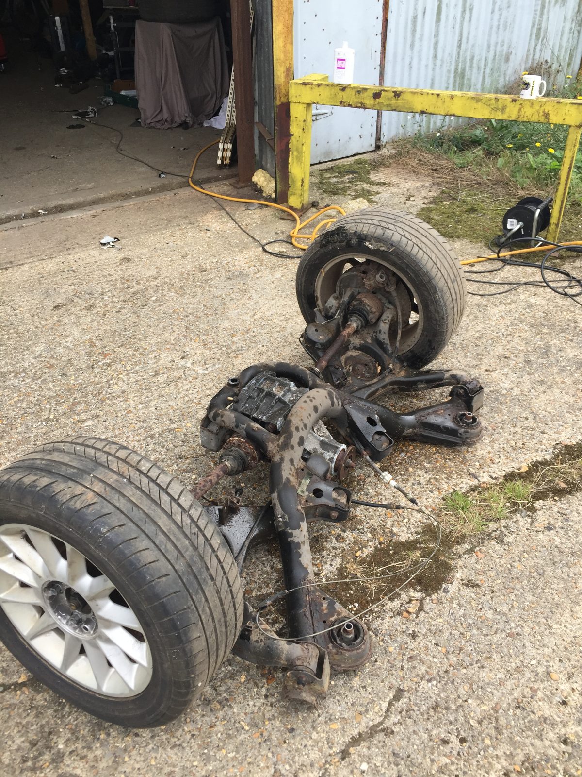 A removed suspension corner, with the wheel still fitted