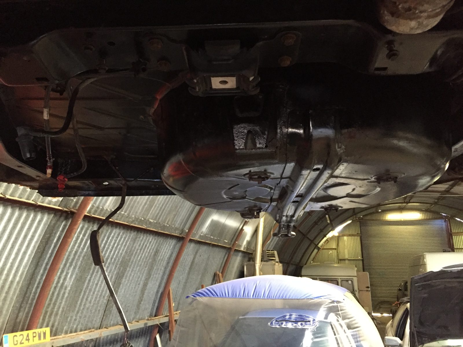 Under the floor, with sections of the metal cut out