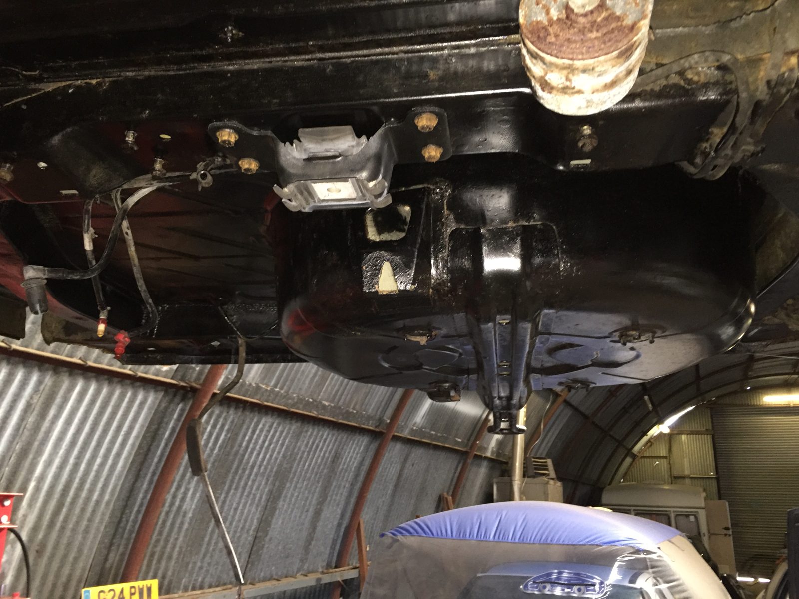 The car on axle stands, with the exhaust off