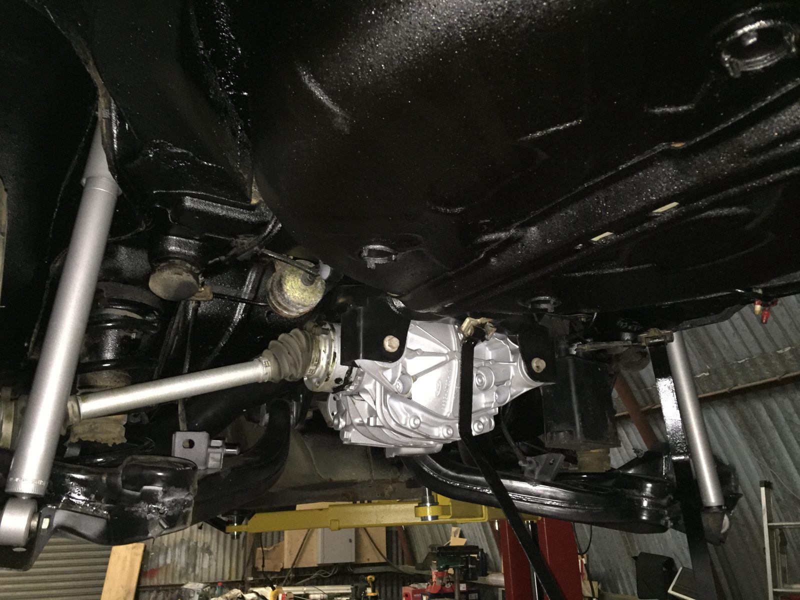 Under the rear, with the exhaust and suspension back in place