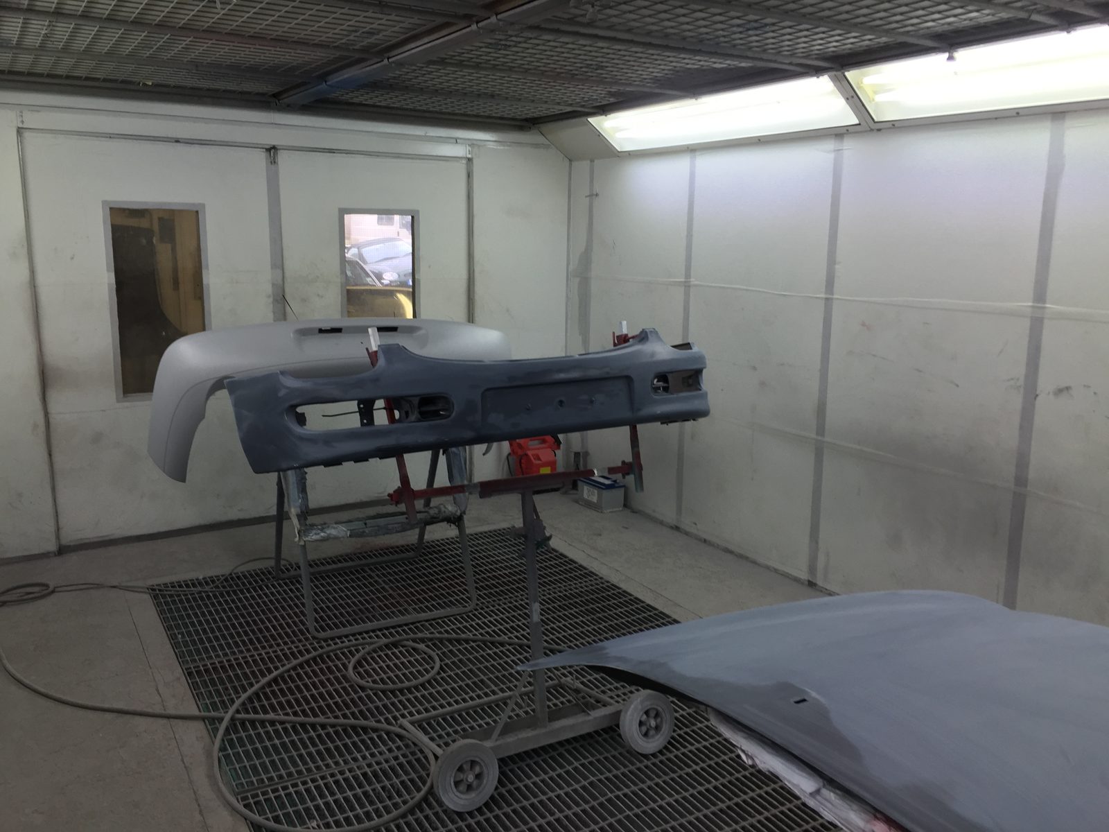 Inside the spray booth, with a panel on a stand