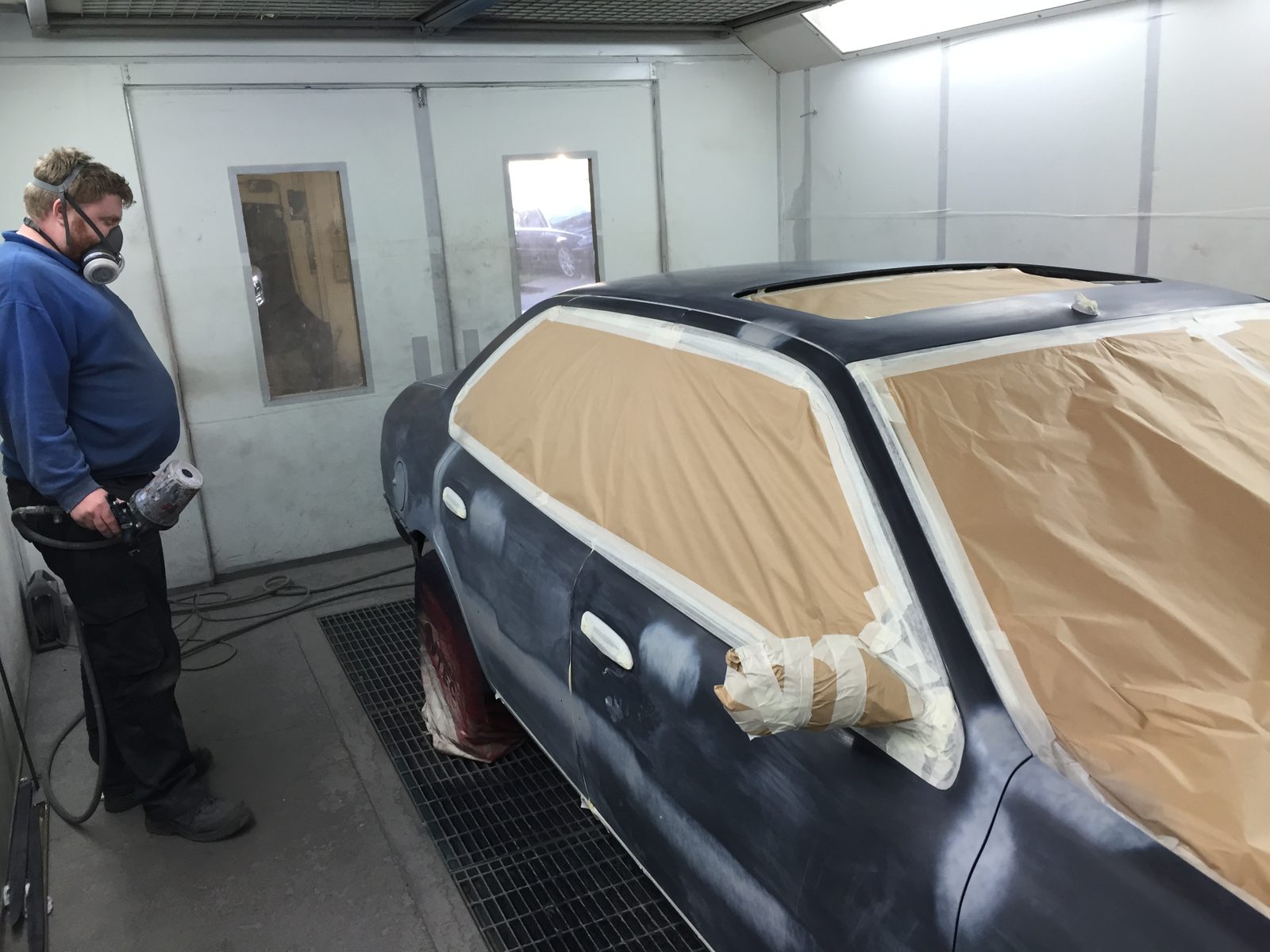 The car in the booth, with the glass masked