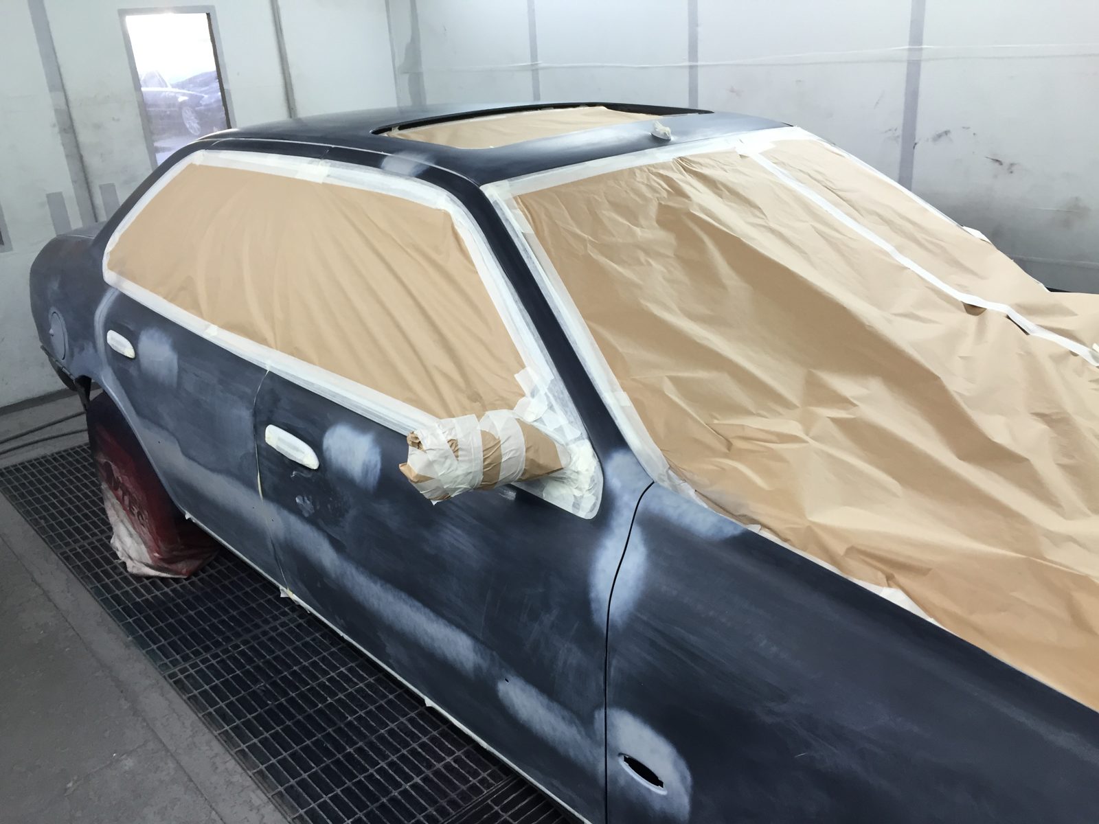 Rear three-quarter in the booth, with the glass masked