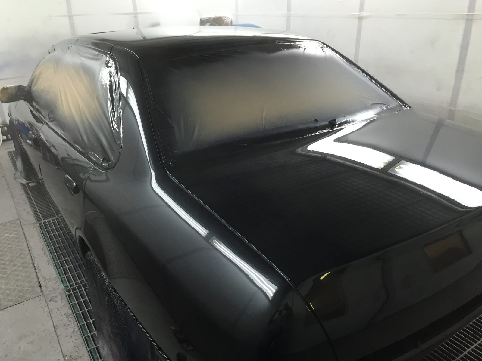 The boot in fresh black paint, with the rear screen still masked