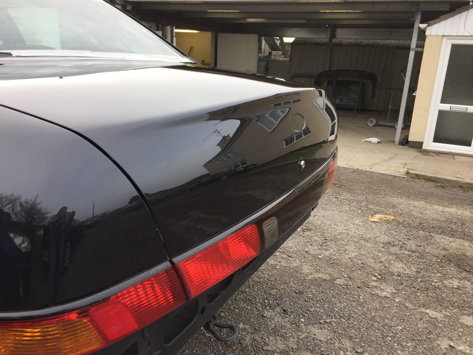 Rear three-quarter outdoors, in black, with the bumper still off