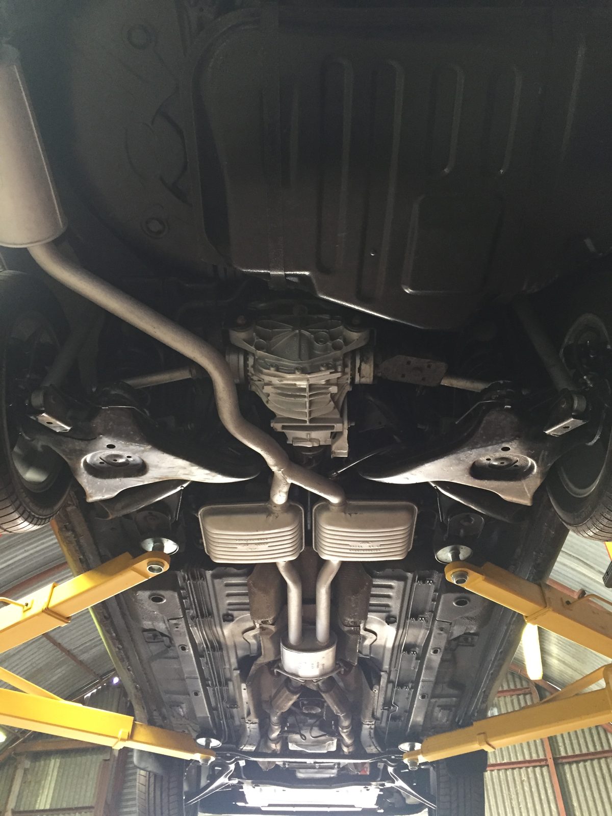 Under the car on the lift, with the exhaust and rear suspension
