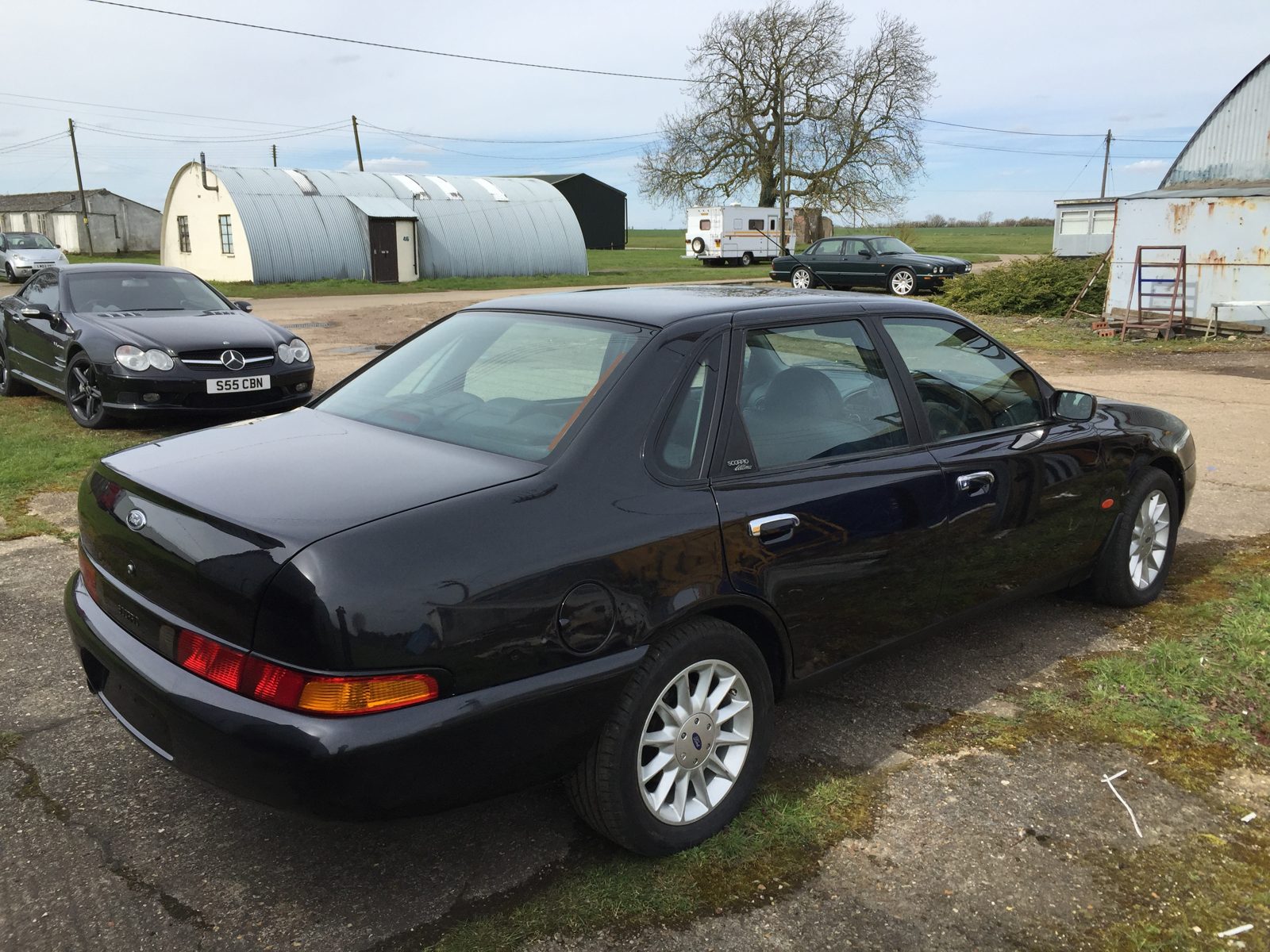 Rear three-quarter of the black Granada Scorpio outdoors